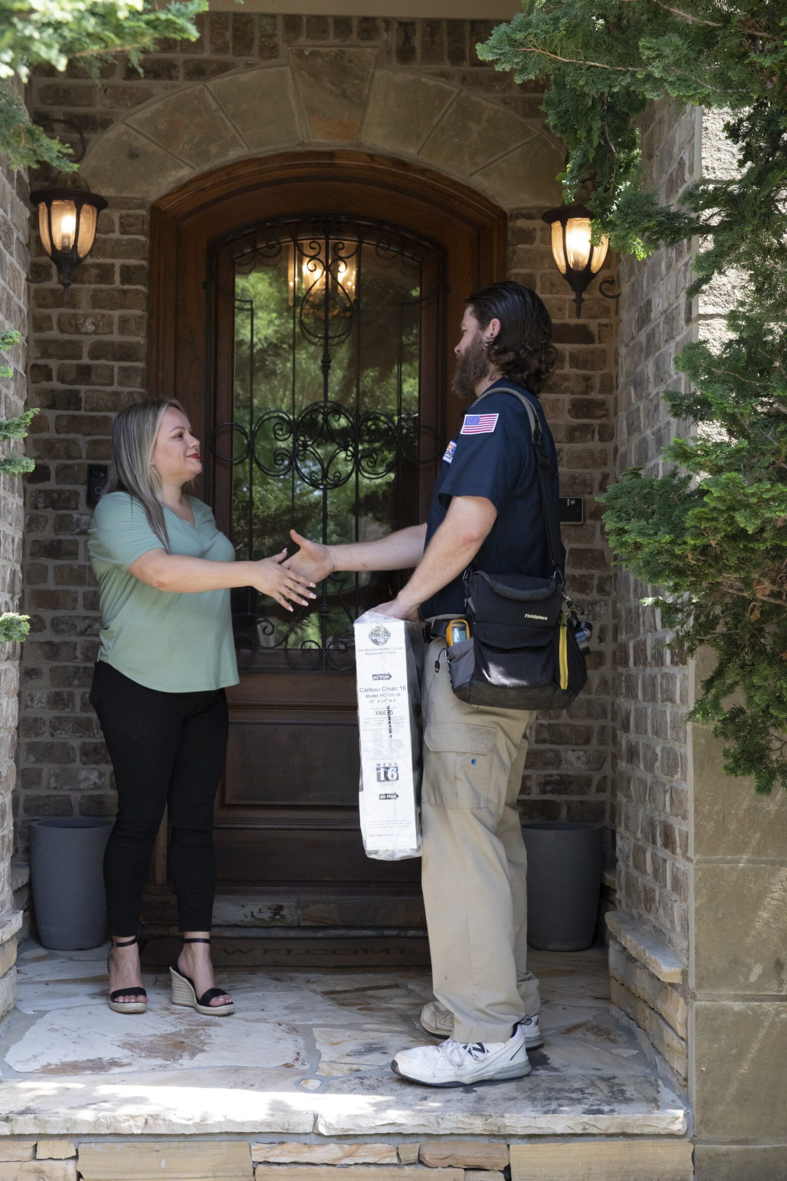 Four Seasons employee shaking customer hand